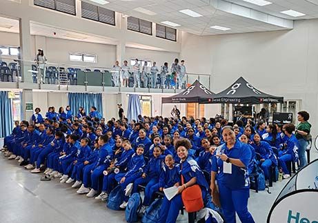 G-Squared Performing Arts students in matching blue tracksuits gathered in a hall